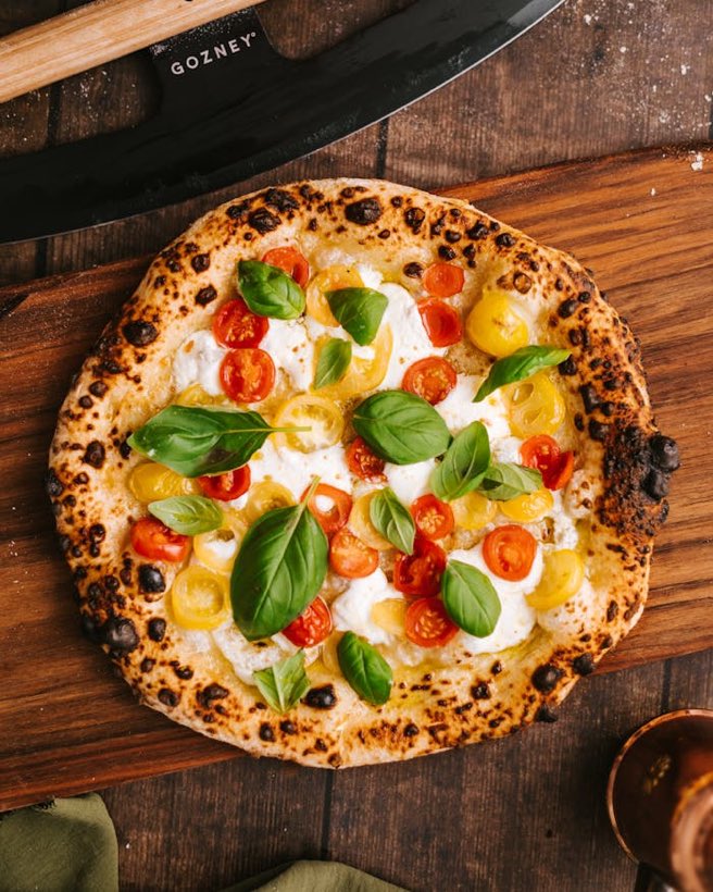 Pizza napoletana con pomodorini gialli e rossi, fior di latte e basilico fresco